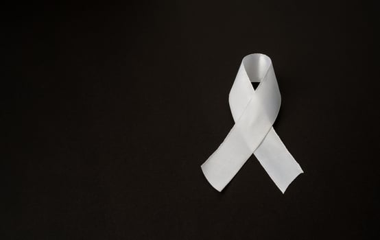 Top view of a white ribbon on a black background. Space for text photo