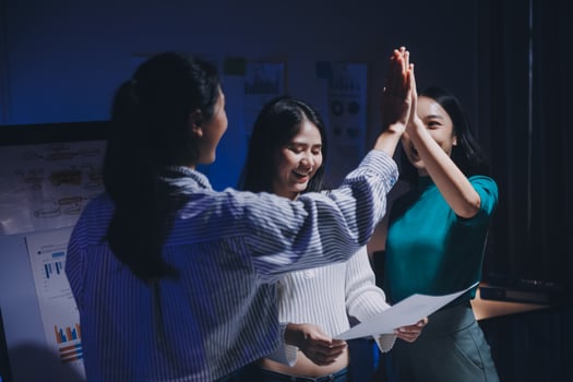 Three women giving high five to each other photo