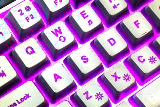 Beautiful purple light RGB keyboard with WASD keys photo