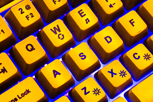 Yellow keyboard with blue light ambience, WASD Keyboard keys photo