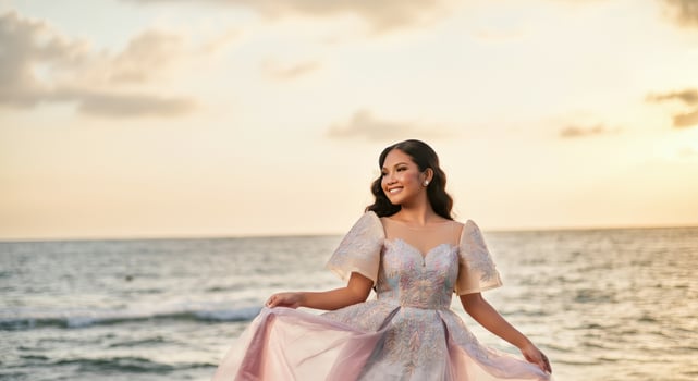 Radiant hispanic young woman enjoying sunset in elegant dress on beach photo