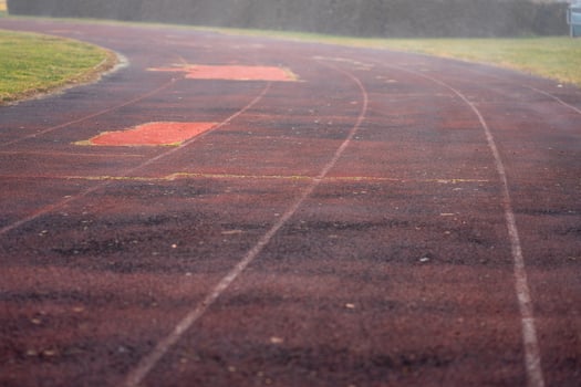 View of an old running track at a street stadium in the early morning photo