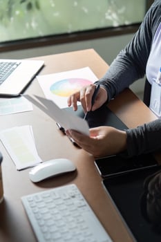Graphic designer working with color palettes and digital tools in a creative space photo