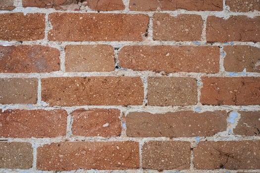 An empty brown brick wall. The old brick wall of the building is outside. With space to copy photo