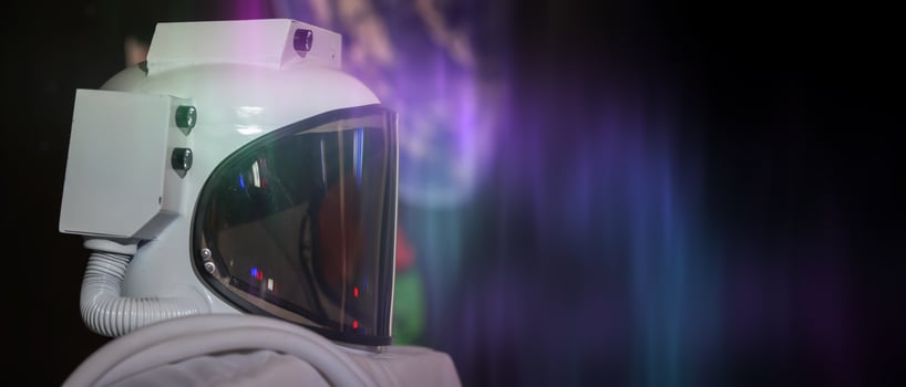 A white astronaut helmet with a purple background photo