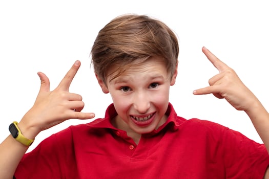 A teenage boy proves something, gestures with his fingers and looks at the camera. photo