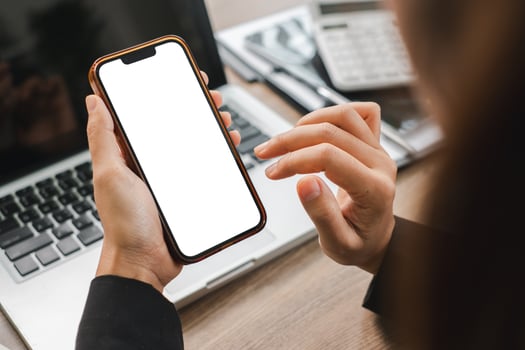 Businesswoman Holding Smartphone with Blank Screen in Office Setting for App Design or Marketing Concept photo
