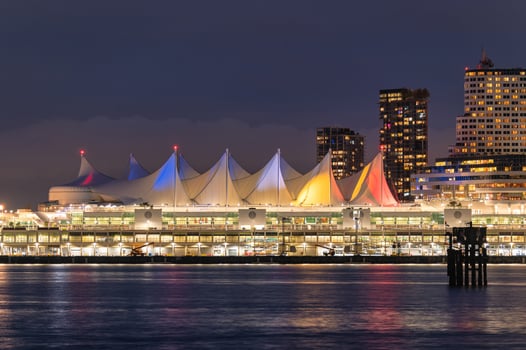 Night market building and skyscraper glowing on coastline in downtown at Stanley Park, Vancouver photo