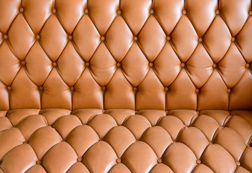Vintage gold leather sofa buttoned of textured photo
