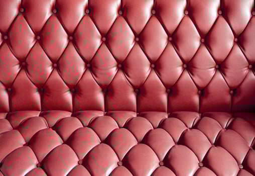 Vintage red leather sofa buttoned of textured photo
