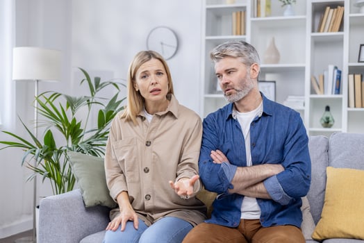 Middle-aged couple engaged in a serious online consultation with a family psychologist, expressing concerns and seeking advice. photo