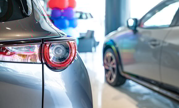 Car parked in luxury showroom. Car dealership office. Car showroom business. New car parked in modern showroom. Auto for sale and rent business. Automobile leasing. Electric automobile. photo