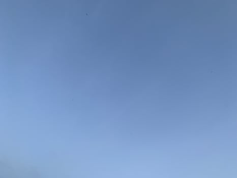 A view of a bright blue sky with white clouds photo