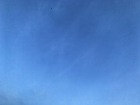 A view of a bright blue sky with white clouds, for background photo