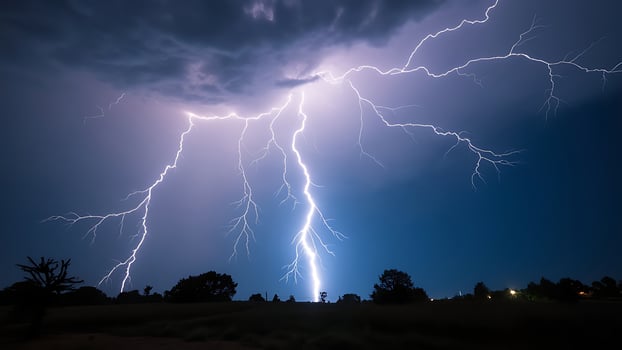 Lightning flashes across the sky at night photo