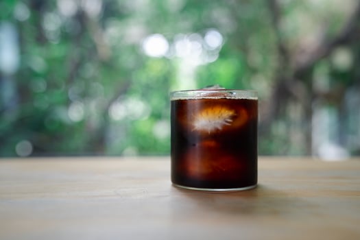 Cold black coffee with ice in glass. photo