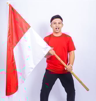 Handsome Indonesian Young Man Holding Country Flag to Celebrate Independence Day of Indonesia photo