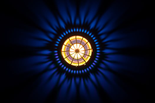 Top view of golden lantern with shadow on dark blue background photo