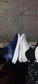 two people sitting on a bench with their shoes on photo