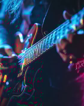 Electrifying Guitar Performance A Close-Up of a Musician's Passionate Play on Stage under Vivid Lighting photo