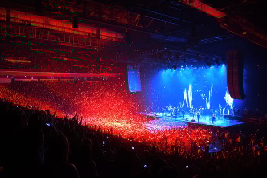 Spectacular Concert Atmosphere A Sea of Red and Blue Lights Illuminating a Massive Crowd at a Live Music Event photo