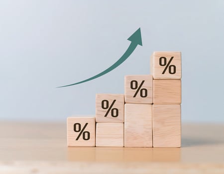Close-up of Wooden Cubes with Percentage Symbol and Growth Arrows photo