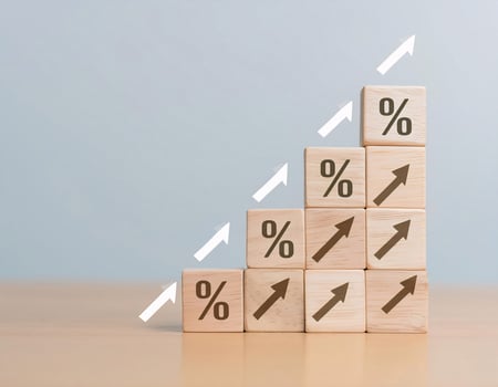 Stacked Wooden Cubes with Percentage Signs and Upward Arrows for Growth Concept photo