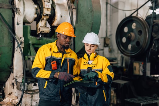 professional engineer inspecting service machine in heavy industry factory photo