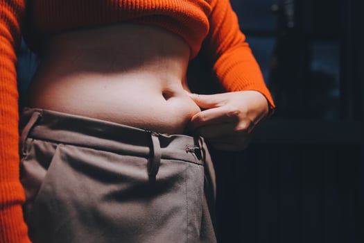 A woman with a large belly and a red sweater photo