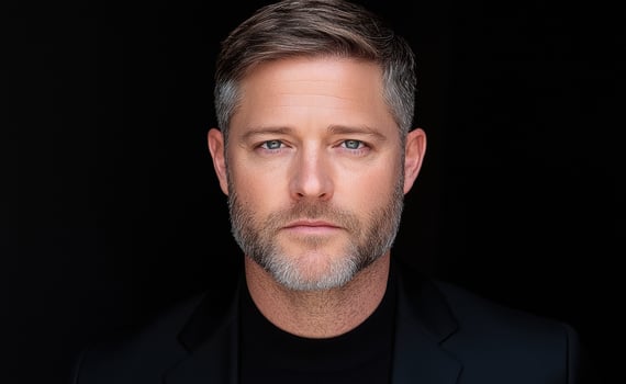 Portrait of a man with graying hair and beard, serious expression photo