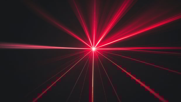 Red laser beam light rays with lens flare on a black background. photo