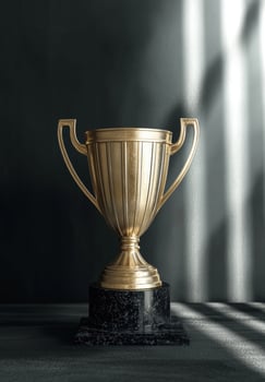 Golden trophy on a dark marble base photo
