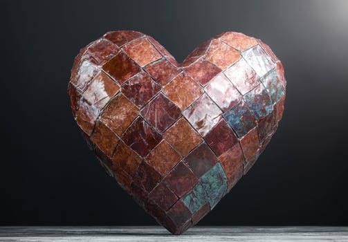 Heart shaped mosaic art piece on a wooden surface photo