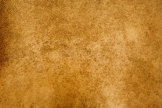Light brown color suede background. Mustard color, suede leather macro photo, material for designer photo