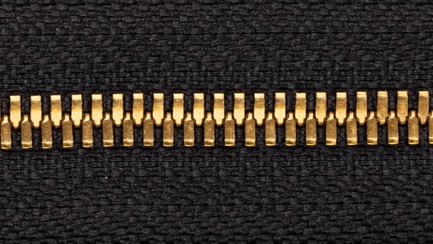 Golden Zipper on Black Fabric Texture photo