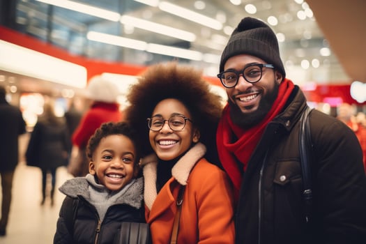 Happy family smiling together at the mall during christmas shopping spree photo
