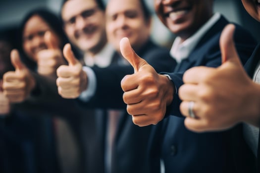 Business people showing thumbs up sign of success photo