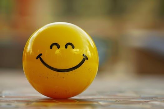 Yellow sphere expressing happiness with a drawn smile photo