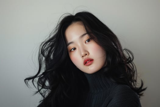 Young asian woman posing with long black hair and trendy makeup photo