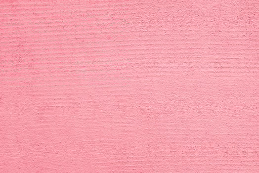 Pink ribbed wall. Pink stucco texture. Designer interior background. Abstract architectural surface. photo