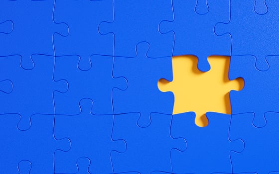 A missing piece in a blue jigsaw puzzle. photo