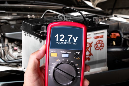 Voltage testing with multimeter on car battery , Car maintenance concept photo