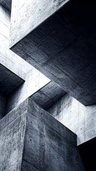 This artistic composition highlights an abstract design with textured concrete surfaces, showcasing sharp angles and unique geometric formations that create visual intrigue photo