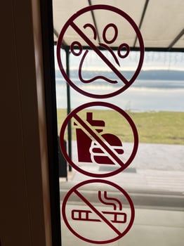 Symbolic window stickers indicating restrictions in a picturesque outdoor setting photo