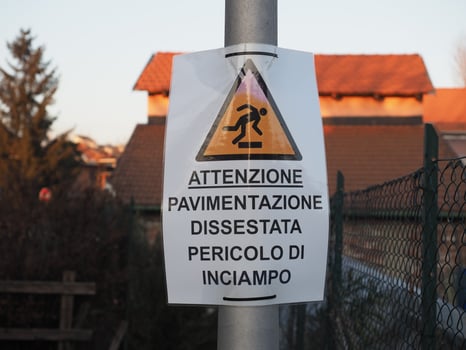 attention uneven pavement danger of tripping sign photo