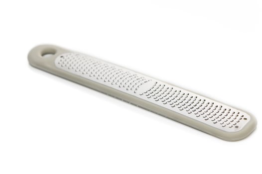 Stylish tool for achieving soft feet during a pampering self-care routine at home in the afternoon sunlight photo