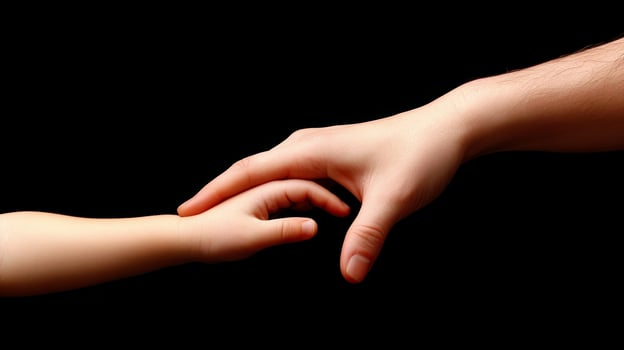 Adult and Child Hands Holding Symbol of Care Protection and Family Bond photo
