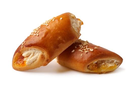 Freshly baked savory rolls filled with cheese and sweet toppings on a white background photo