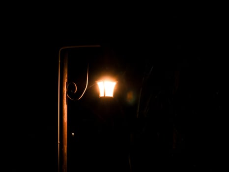 old moody style lamp electric decoration at black night in the dark. photo