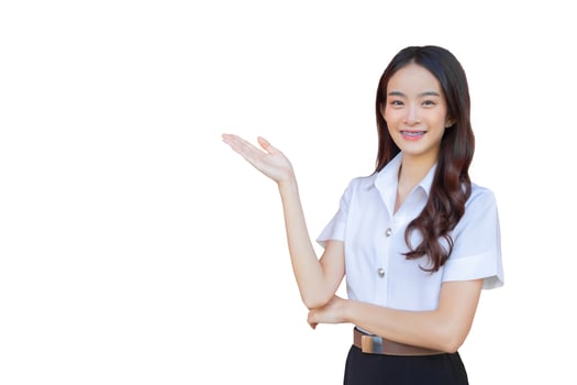 Cute Asian university girl in the university uniform stands and smiles happily with braces on her teeth while she confidently while she looks at the camera while isolated white background. photo